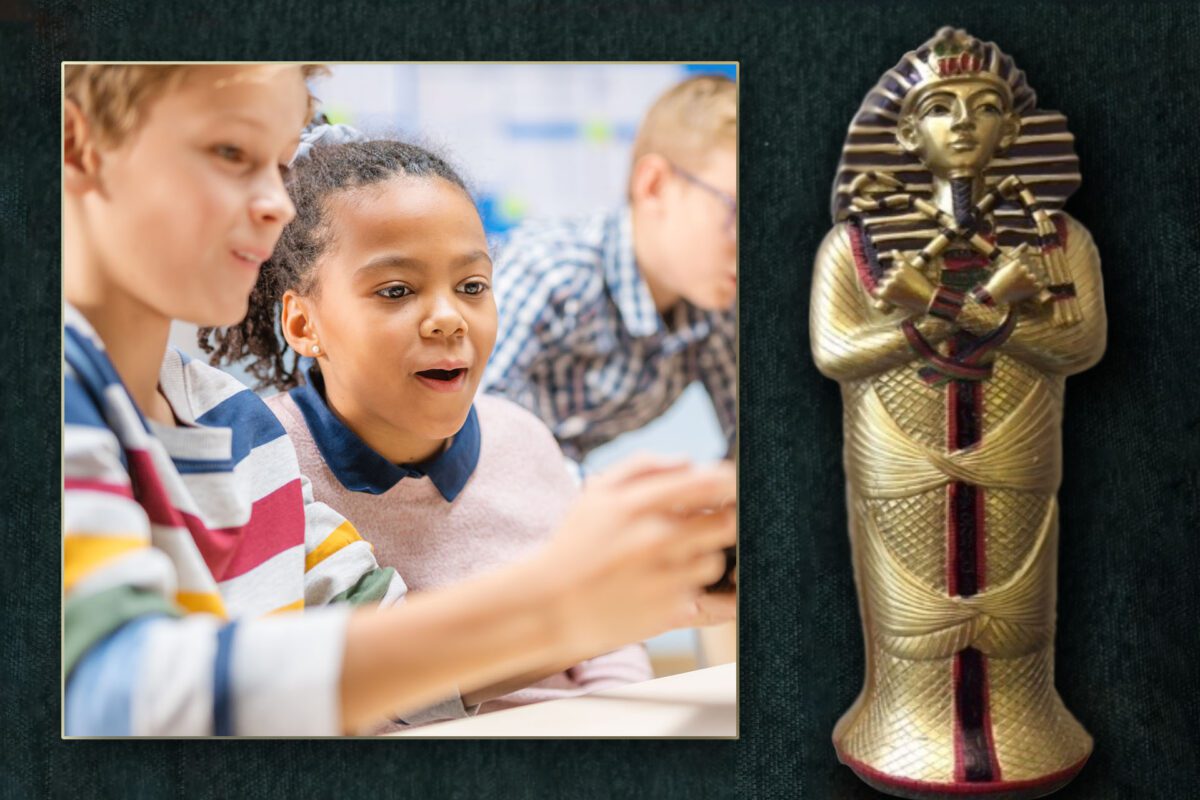 A hands-on history experience featuring an Egyptian pharaoh statue with a child standing in front.