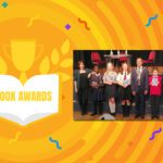 A group of people standing in front of an orange background at a local book award ceremony.