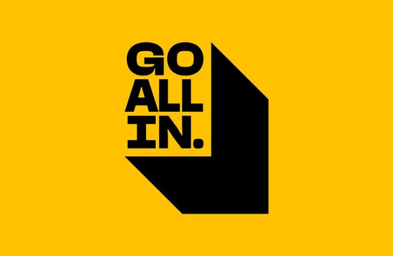 Bold black text reads "GO ALL IN." on a yellow background, with a large black arrow pointing downward next to the text—inviting you to read more and dive into bold, impactful reading.