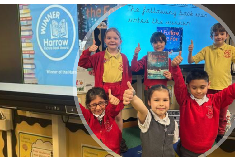 Five children in school uniforms give thumbs up in a classroom, standing before a screen announcing I Follow the Fox by Rob Biddulph as the winner of the Harrow Picture Book Award.